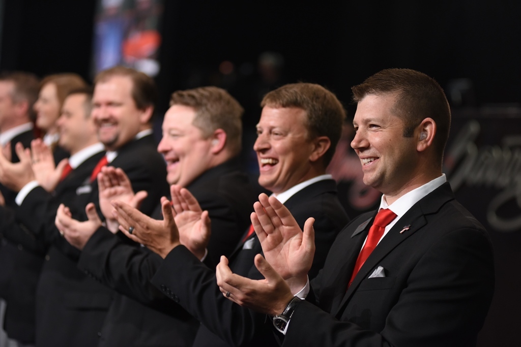 Ready to roll: the Barrett-Jackson auctioneering team, led by Joseph Mast (right), line up on the block prior to the start of each auction day.