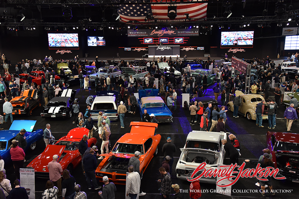 Guests admiring the Barrett-Jackson Cup competitors before they cross the block.