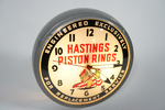 1950S HASTINGS PISTON RINGS LIGHT-UP CLOCK - Front 3/4 - 257371