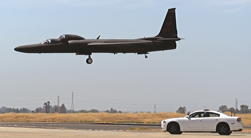 A mobile chase car pursues a U-2 Dragon Lady as the aircraft prepares to land. (Photo by U.S. Air Force Airman 1st Class Romaon A. Adelan)