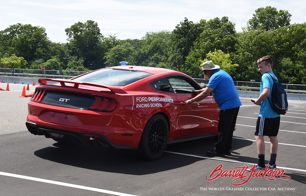 A teenager ready for the ride of his life with a professional driver at the Ford Ride 'N Drives today.