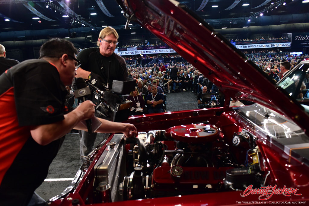 Velocity's Steve Magnante and cameraman provide insight on an auction vehicle for the live TV audience.