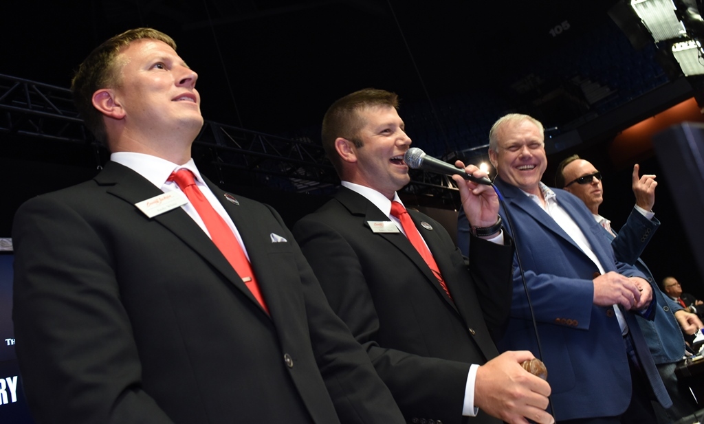 Auctioneers Wade Cunningham and Joseph Mast with Craig Jackson and Steve Davis on the auction block.