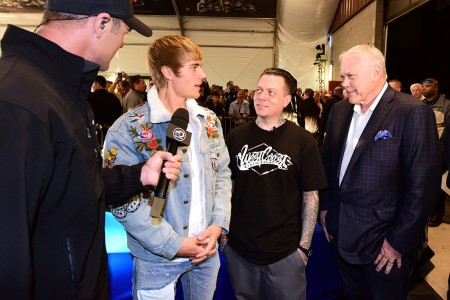 Discovery Channel's Chris Jacobs interviews Justin Bieber, West Coast Customs CEO Ryan Friedlinghaus and Barrett-Jackson CEO Craig Jackson in the staging lanes.