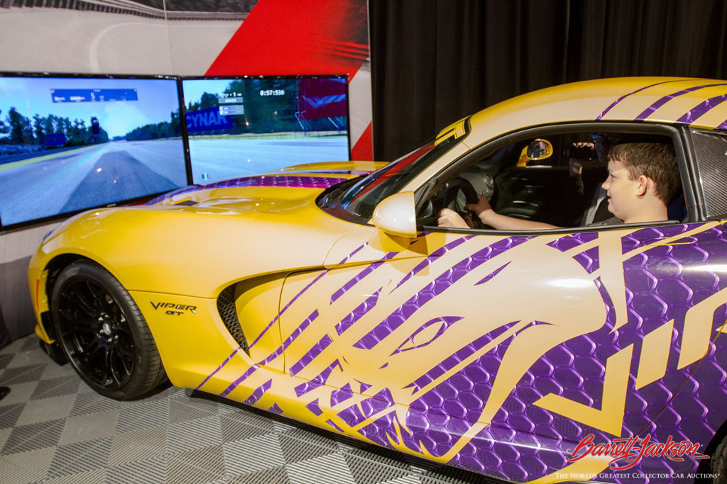 A young driver-in-the-making checks out a Dodge Viper simulator in the Sponsor Pavilion.