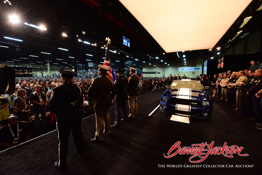 Lot #3004, the 2007 Shelby GT500 Super Snake, flanked onstange by the Southern Nevada Combined Honor Guard and Las Vegas first responders.