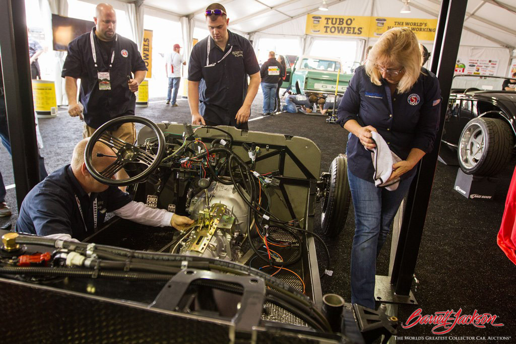 The Factory Five team busy doing a custom hot rod build at the DIY Pavilion.