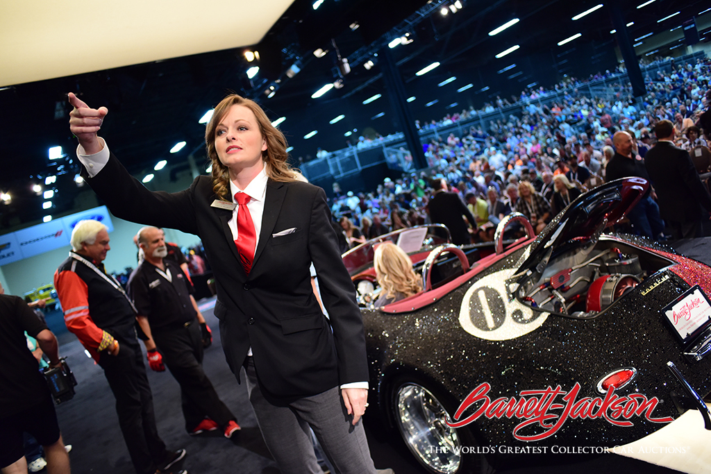 Bidder assistant Camille Booker looks for another bid on Lot #636 – a 1956 Porsche Speedster Outlaw Re-creation covered with Swarovski crystals – that got a lot of attention during the event. It sold for $110,000.