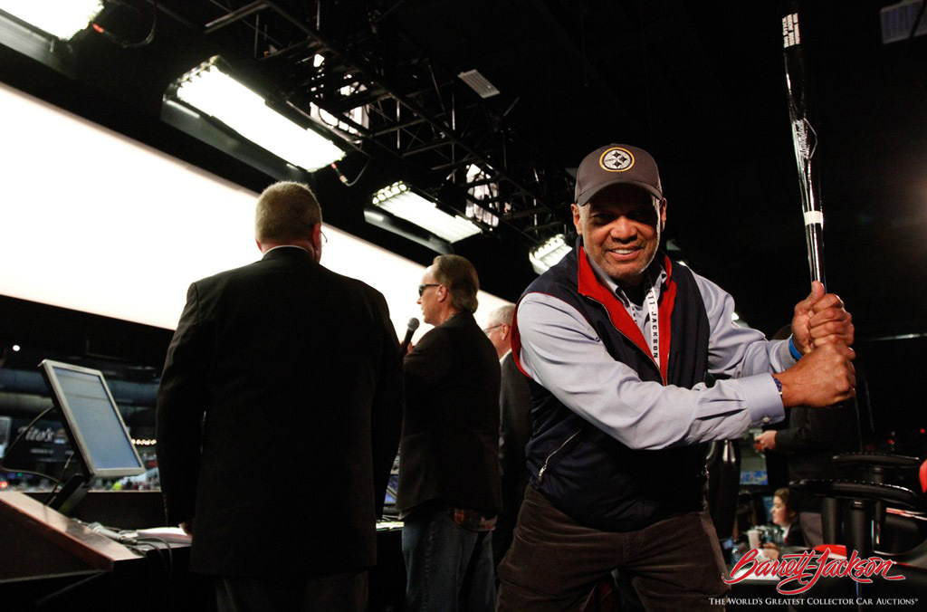 Baseball great Reggie Jackson hams it up behind the scenes on the auction block.