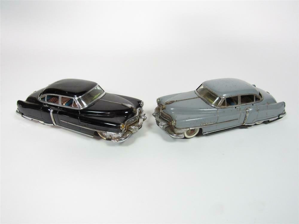 Lot of two 1950s Cadillac Sedan tin litho friction toy cars i